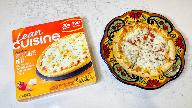 A Lean Cuisine Four Cheese on a patterned plate next to its box