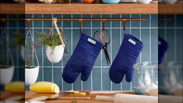 blue oven mitts hanging in kitchen