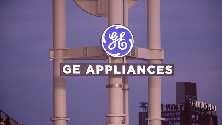 GE Appliances logo on a factory against a blue sky