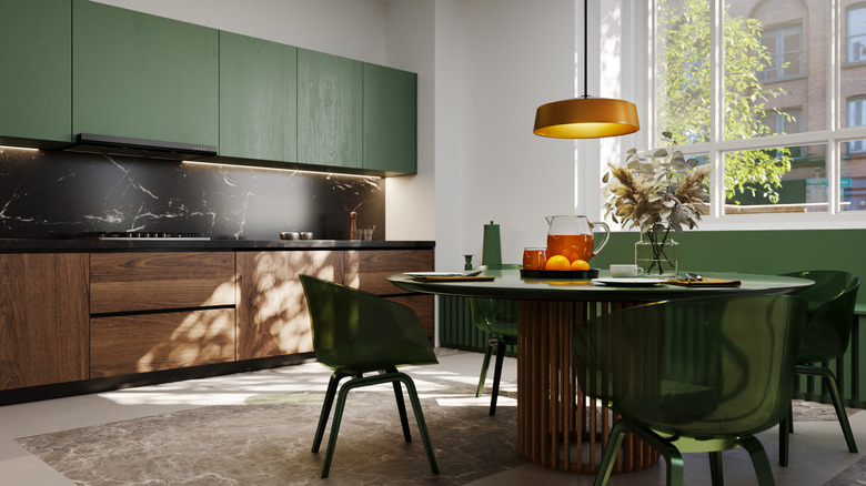 Kitchen with wooden cabinets and green acccents