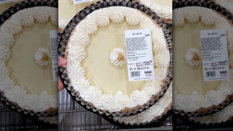 Hand holding key lime pie at Costco.
