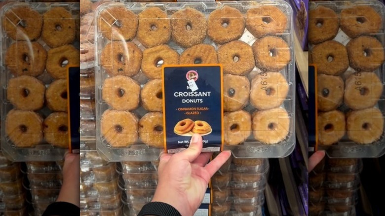 Hand holding a package of mini croissant donuts.