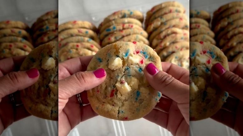 Hand holding a red, white, and blue cookie in front of the full package.
