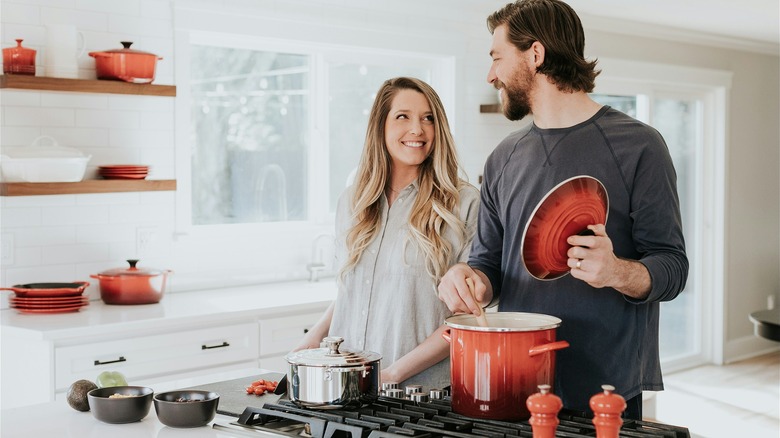 Young, white couple cooking dinner with Le Creuset cookware
