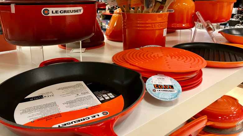 Store table with various Le Creuset items for sale