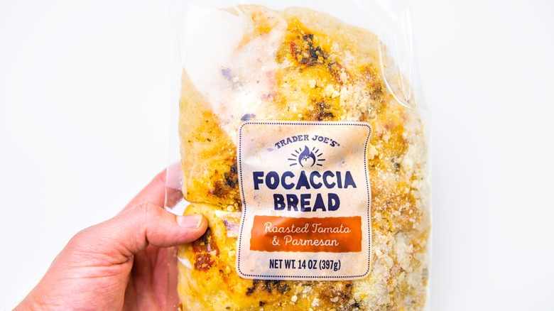 Hand holding focaccia bread