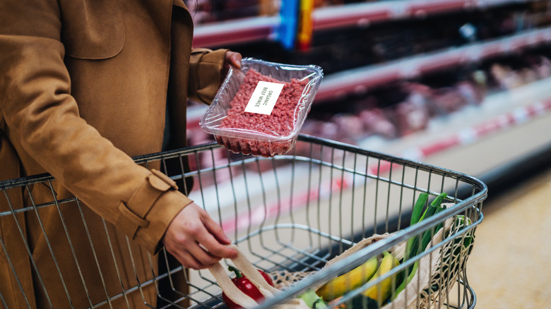 Woman in supermarket with ground beef