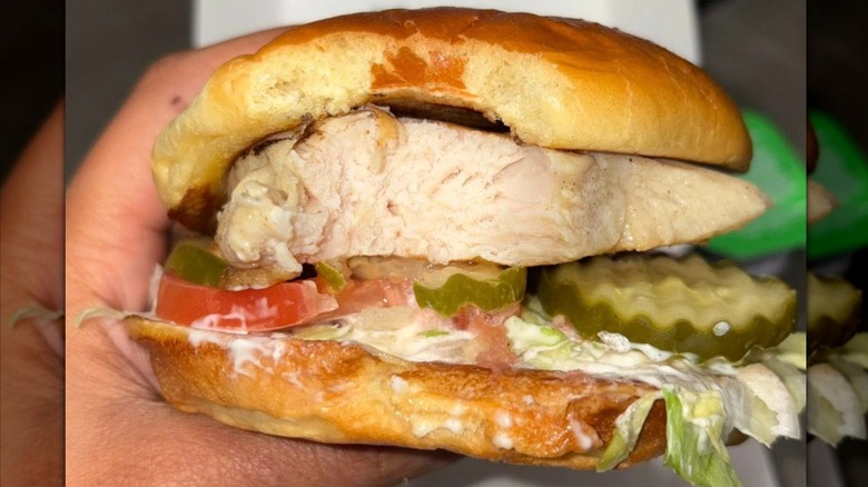 A hand holds a Culver's Grilled Chicken Sandwich