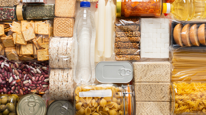 Various pantry staples, including crackers and nuts, on a table