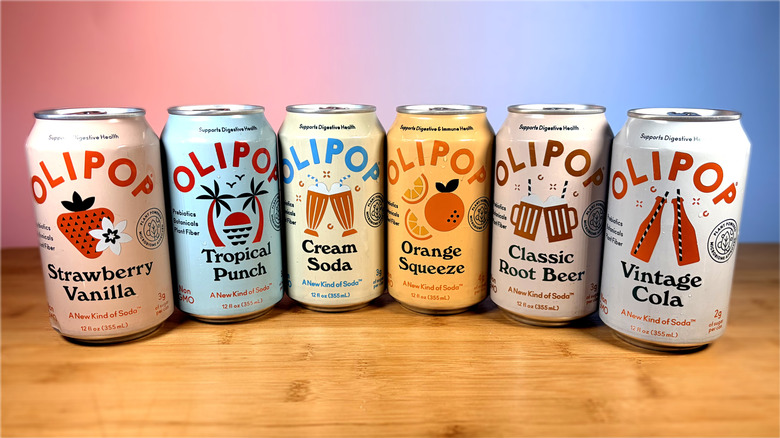 Six cans of Olipop prebiotic soda on a table