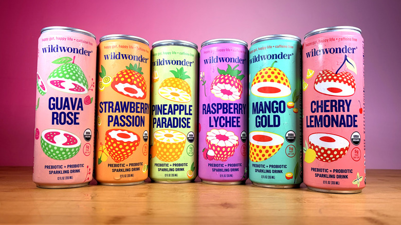 Six cans of Wildwonder prebiotic sodas lined up on table