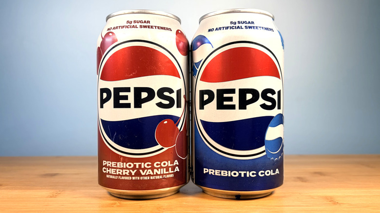Two cans of Pepsi prebiotic colas on a table