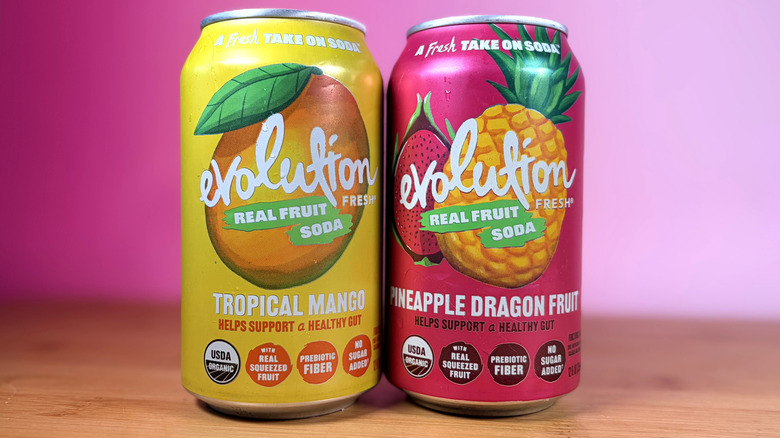 Two cans of Evolution Fresh prebiotic sodas on a table