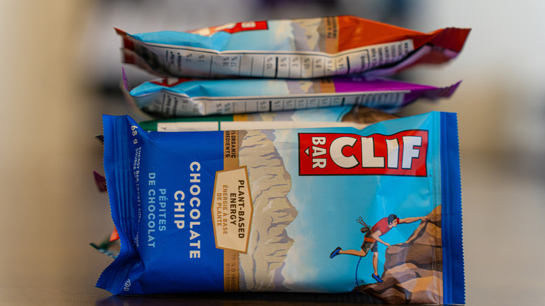 A pile of Clif bars against a blurry background