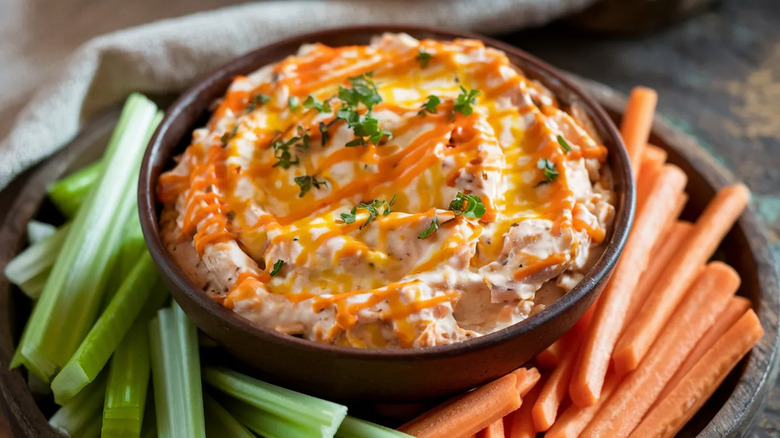 bowl of buffalo chicken dip with celery and carrots