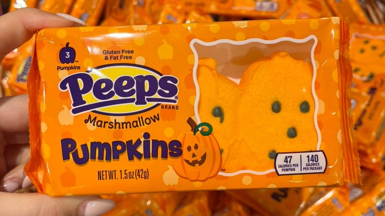 Close-up of a hand holding a package of Peeps marshmallow pumpkins