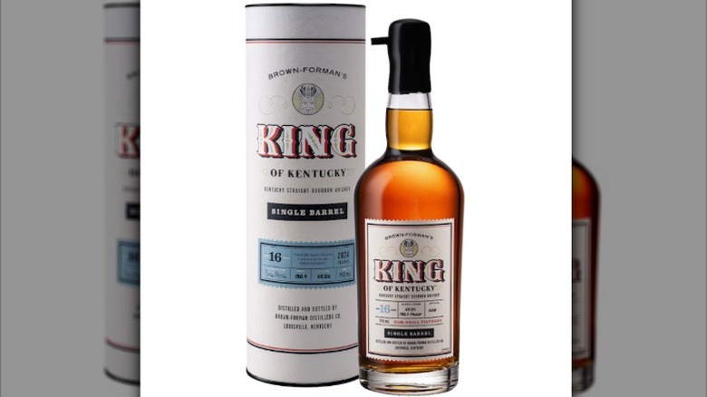 A bottle of King of Kentucky 2024 bourbon next to its packaging tube