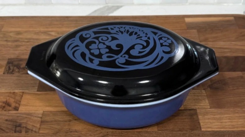Pyrex casserole dish with black lip with floral design and blue base
