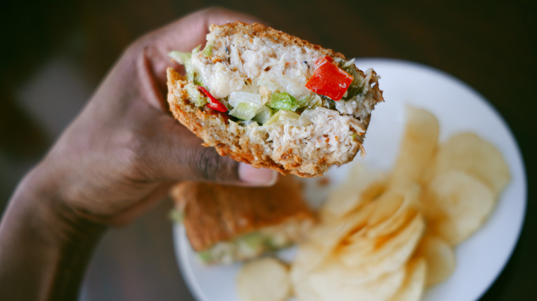 hand holding tuna salad sandwich