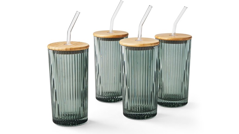 Four glasses with bamboo lids and straws