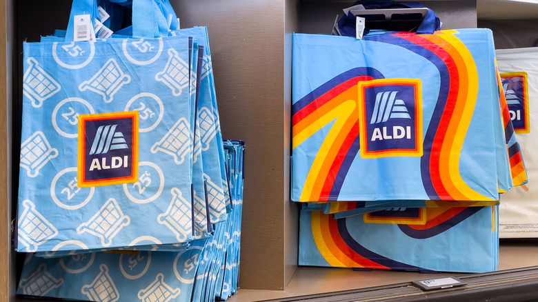 Blue reusable grocery bags with the Aldi logo printed on them