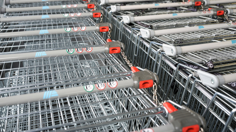 A row of Aldi shopping carts chained together by the quarter deposit mechanism