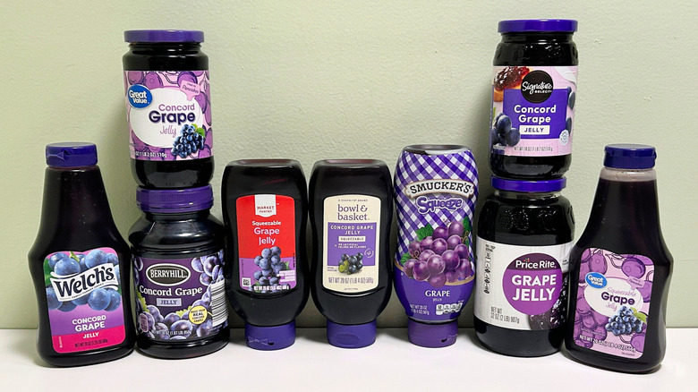 Several jars of grape jelly from different brands arranged in two vertical rows