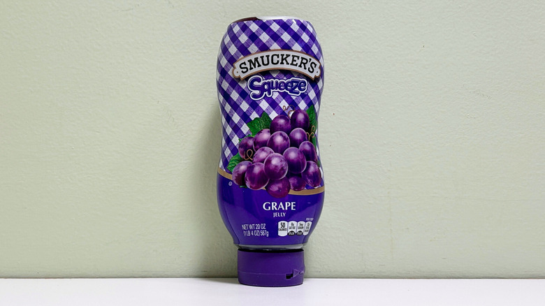 A container of Smucker's Squeeze Grape Jelly