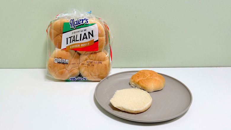 A bag of Maier's Premium Italian Kaiser Rolls next to a plate of hamburger buns