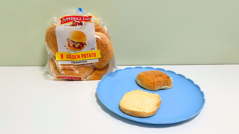 A bag of Pepperidge Farm Golden Potato Hamburger Buns next to a plate of hamburger buns