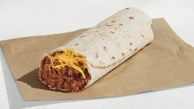 A Chili Cheese Burrito from Taco Bell placed on a brown paper