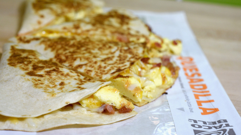 Taco Bell quesadilla placed on a wooden table
