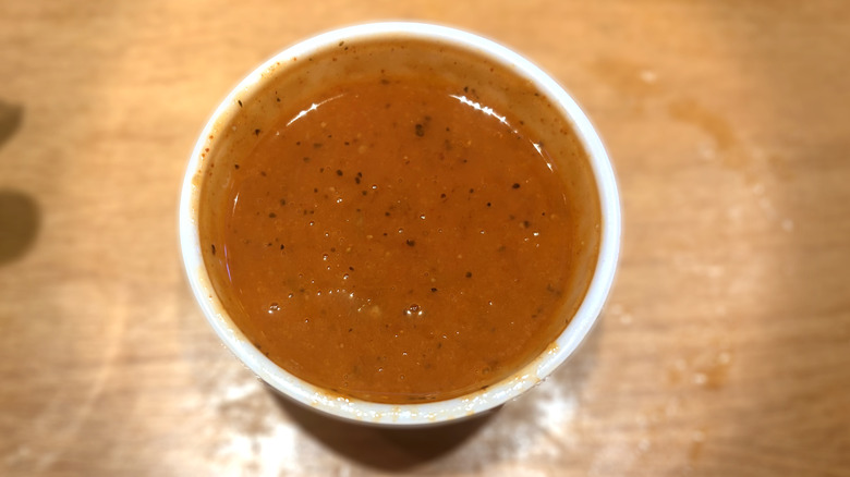 plastic container of hot sauce