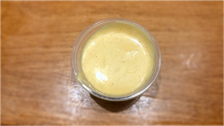 plastic container of honey mustard sauce