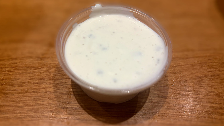 plastic container of blue cheese sauce
