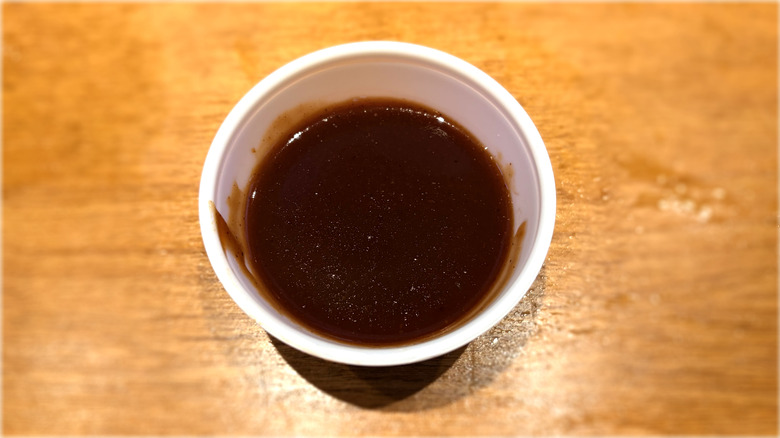 plastic container of barbecue sauce