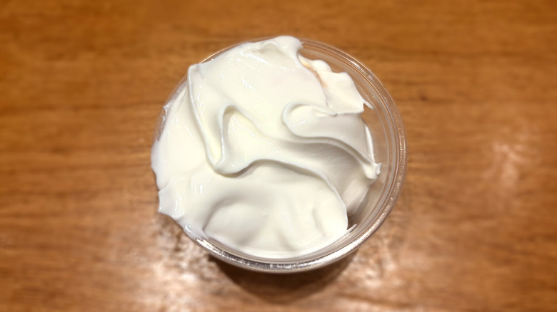 plastic container of sour cream