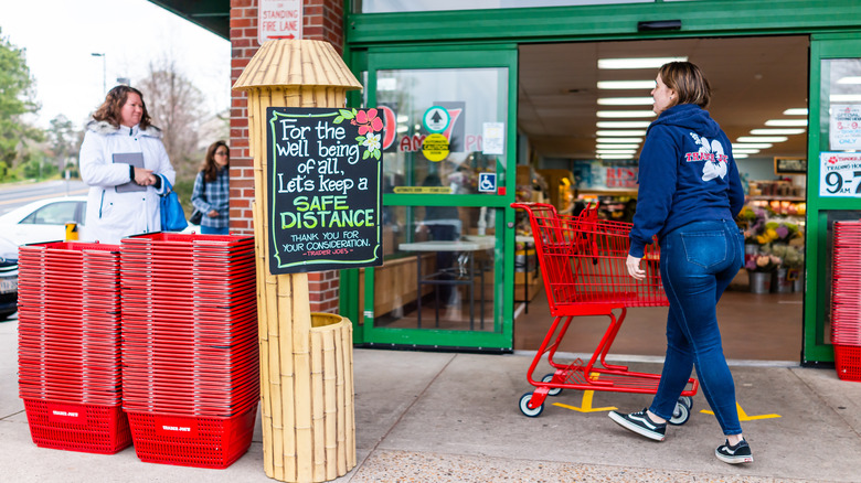 Trader Joe's employee pushing grocery cart