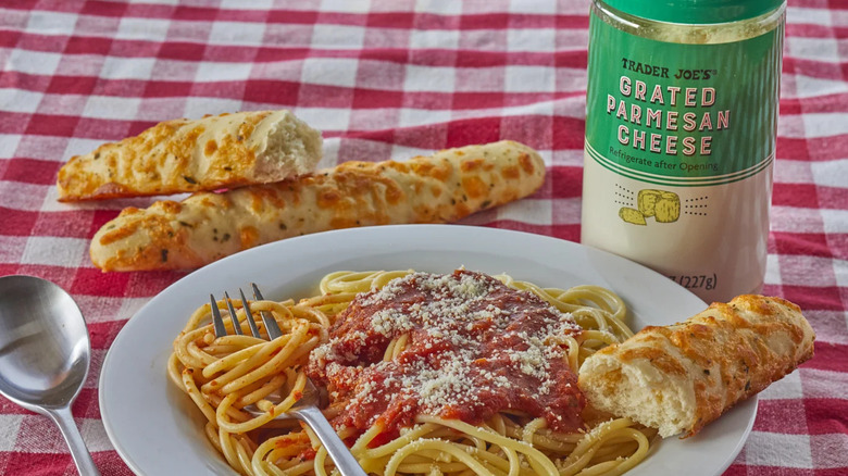 Plate of pasta with Trader Joe's grated Parmesan bottle
