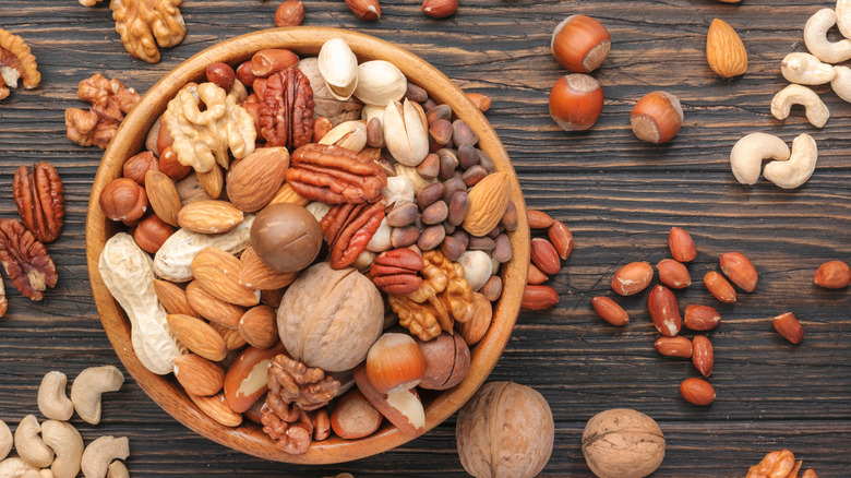 bowl of nuts on wooden background