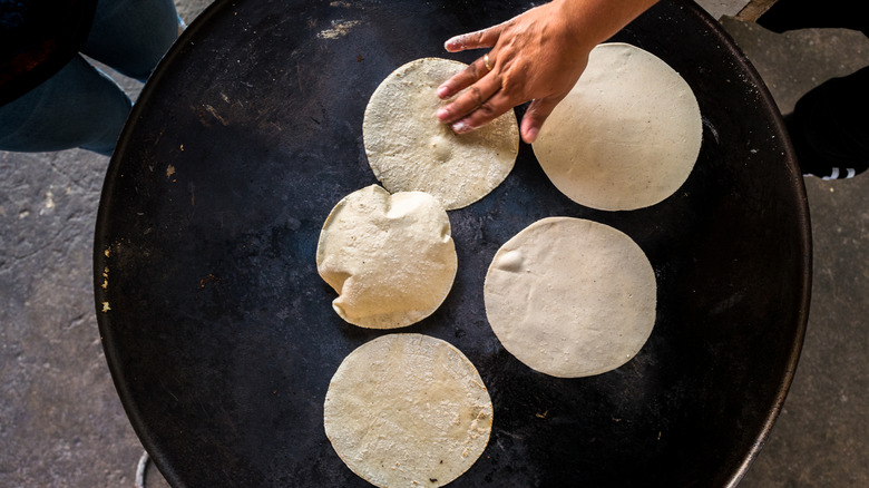 Corn tortillas on a comal