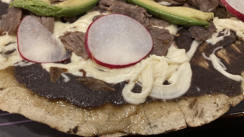 Tlayuda topped with tasajo