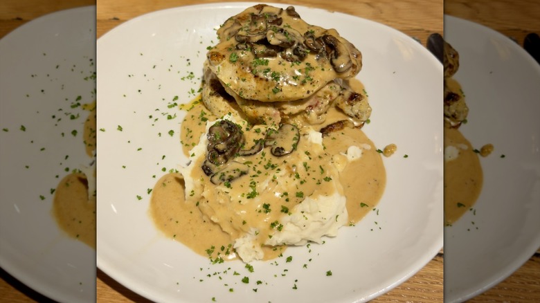 Close-up view of a plate of Olive Garden's stuffed Chicken Marsala