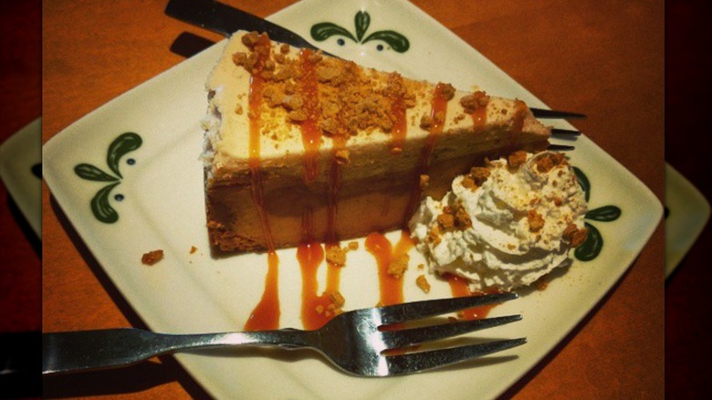 A slice of Olive Garden pumpkin cheesecake on plate with two forks