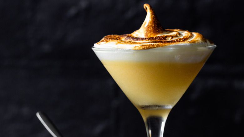 Lemon meringue cocktail in a cocktail glass with torched meringue on top