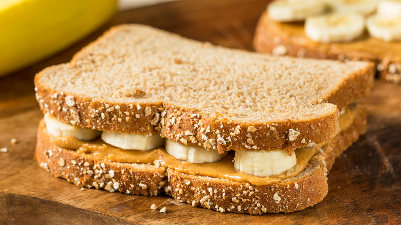Peanut butter and banana sandwich on a wooden board