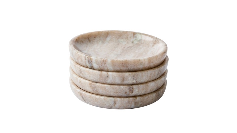 Four marble coasters on top of each other against a white background