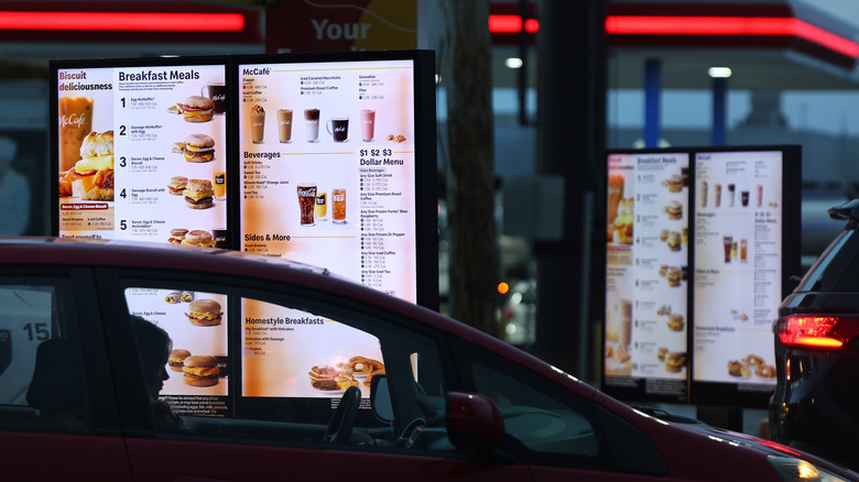 A car pulling up to a McDonald's drive-thru