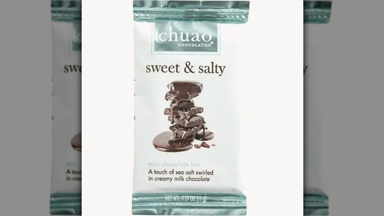 Sweet and salty chocolate bar on white background