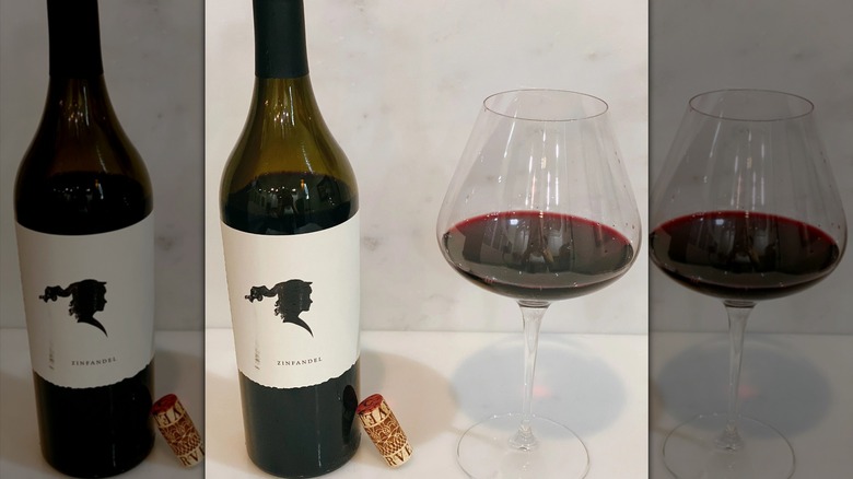 Corvelia bottle of wine with a white and black label and a glass of red wine next to it.